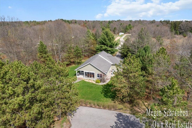 aerial view featuring a wooded view