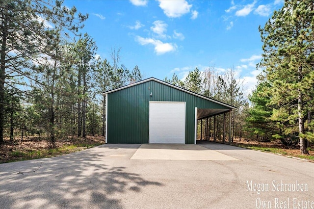 garage featuring a garage and aphalt driveway