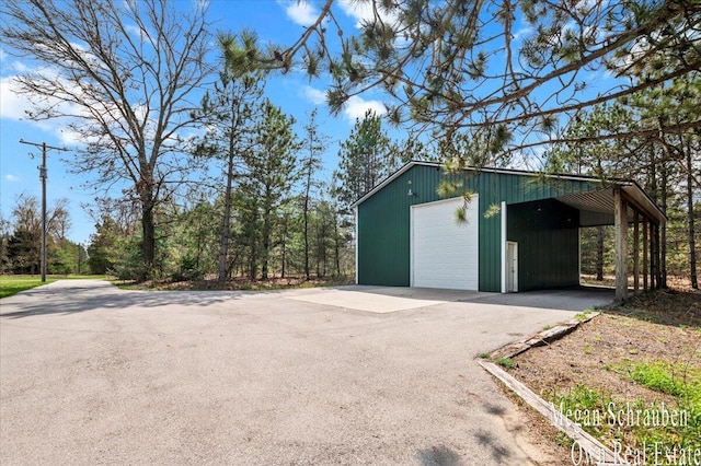 garage featuring a garage and aphalt driveway