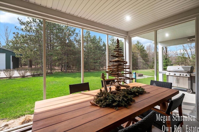 sunroom featuring outdoor dining space