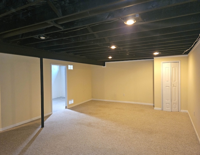 finished basement featuring baseboards and carpet