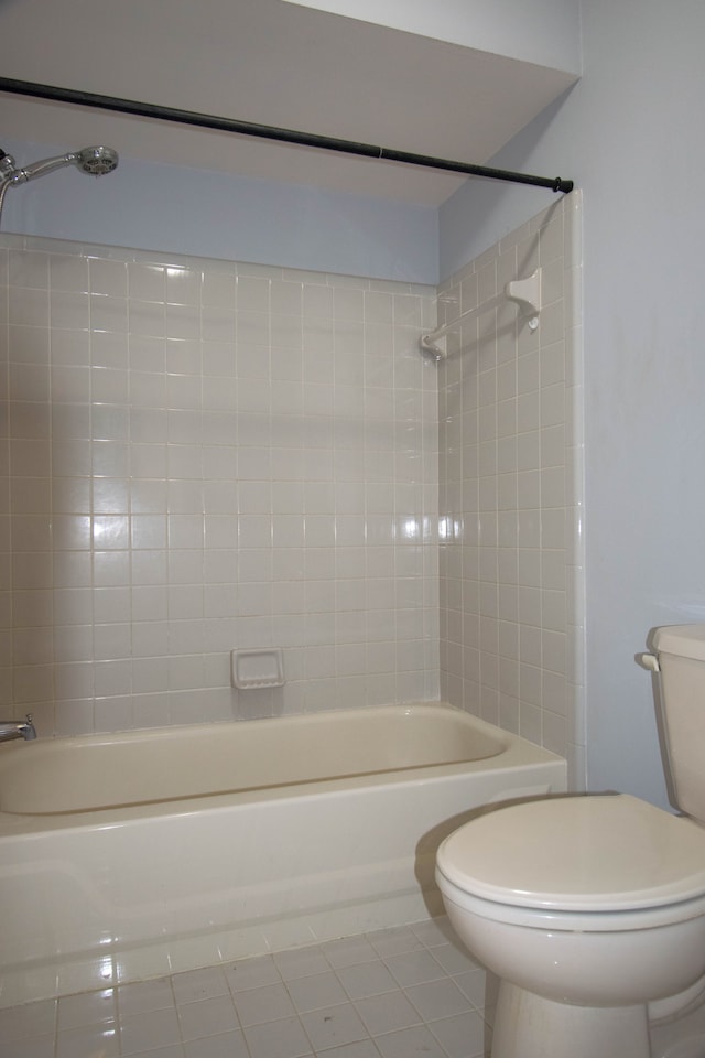 full bathroom featuring tile patterned flooring, washtub / shower combination, and toilet
