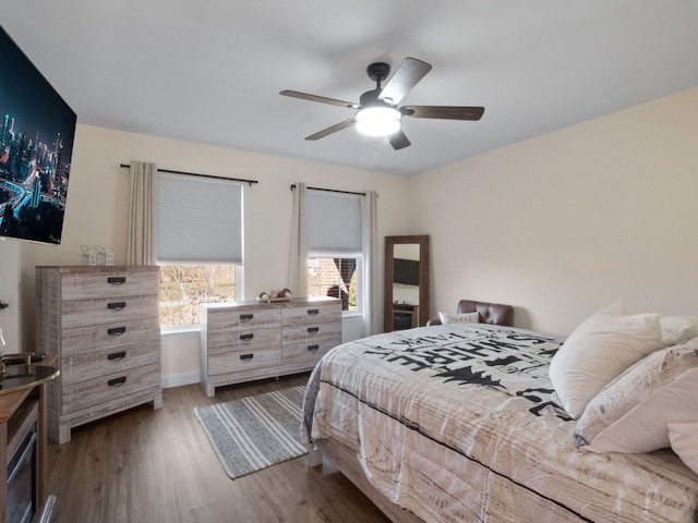 7136 N Meadows Trl, Dexter, MI 48130 - bedroom with baseboards, ceiling fan, and wood finished floors