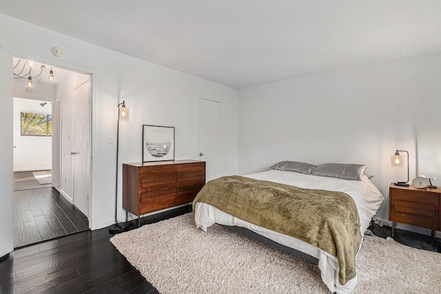 bedroom featuring dark wood-type flooring and baseboards
