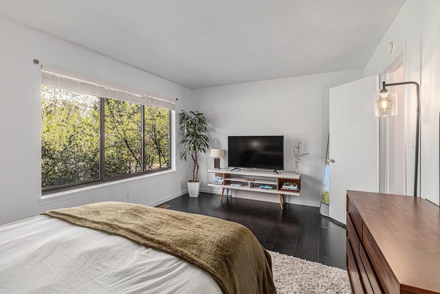 bedroom featuring baseboards and wood finished floors