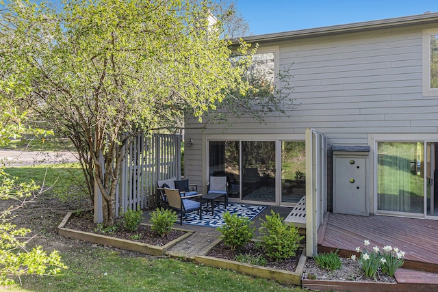 back of property with fence and a deck