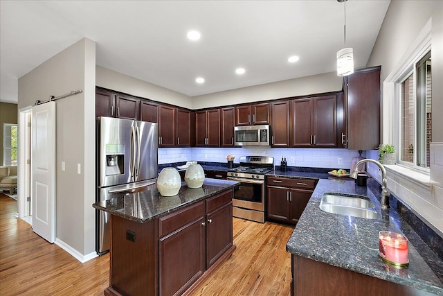 29816 Trailwood Dr, Warren, MI 48092 - kitchen with stainless steel appliances, a sink, a center island, light wood finished floors, and dark stone countertops
