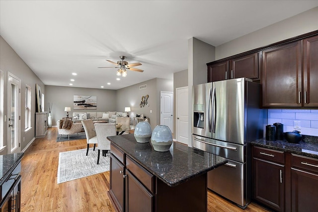 29816 Trailwood Dr, Warren, MI 48092 - kitchen featuring stainless steel refrigerator with ice dispenser, dark brown cabinetry, dark stone countertops, and light wood-type flooring