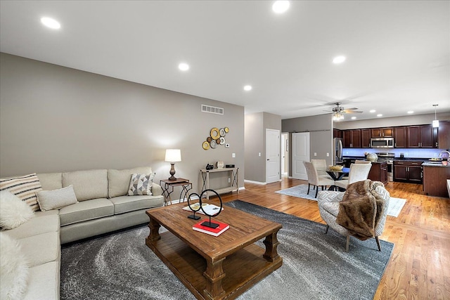 29816 Trailwood Dr, Warren, MI 48092 - living room featuring recessed lighting, a ceiling fan, light wood-style flooring, and baseboards