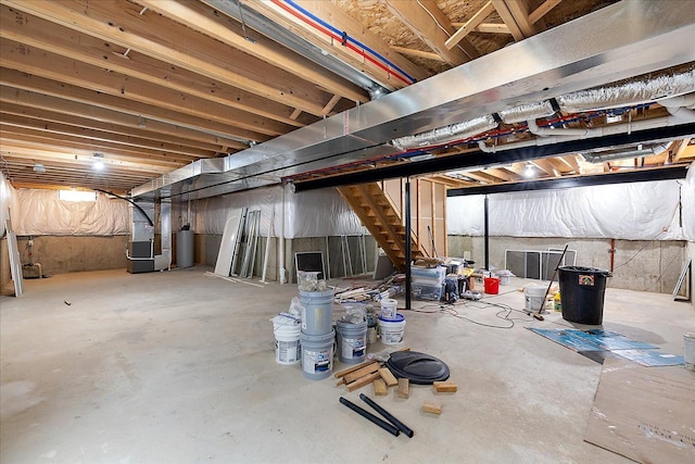 29816 Trailwood Dr, Warren, MI 48092 - unfinished basement featuring water heater, heating unit, and stairway