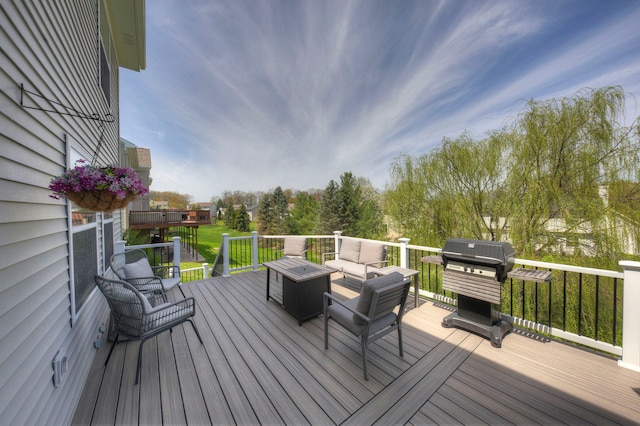 wooden terrace featuring an outdoor hangout area and a grill