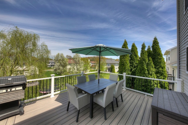 wooden terrace with a residential view and outdoor dining space