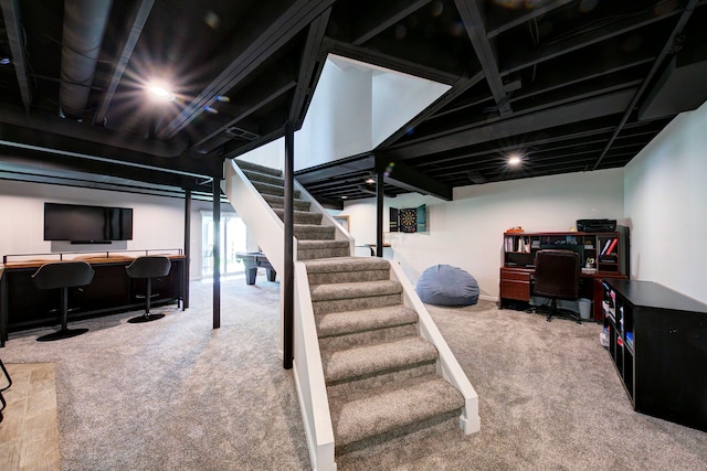 basement featuring carpet floors and stairway