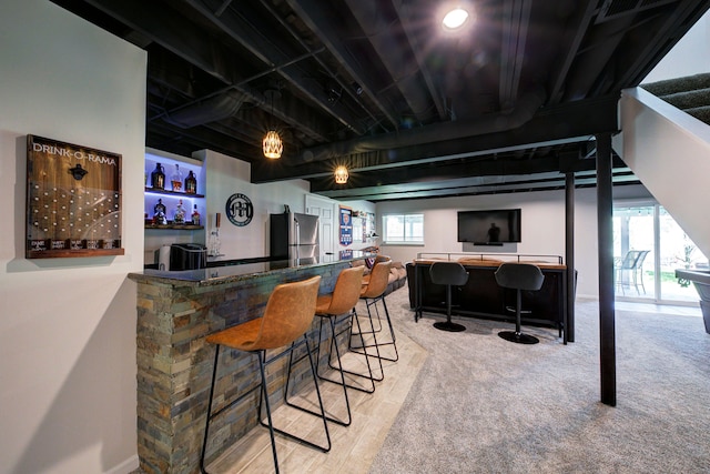 bar featuring freestanding refrigerator, carpet, and a community bar