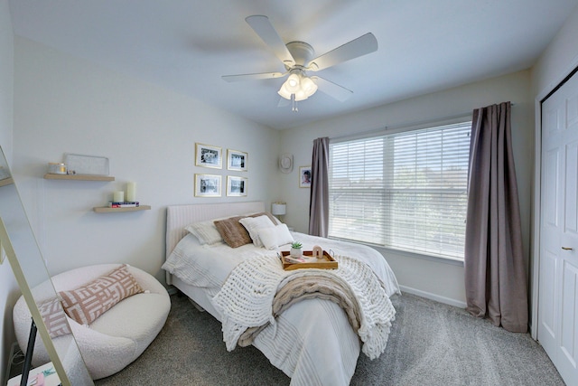 carpeted bedroom featuring baseboards and a ceiling fan