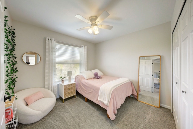 bedroom featuring ceiling fan, a closet, and light colored carpet