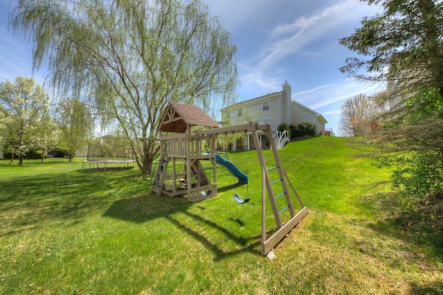 view of playground featuring a trampoline and a yard