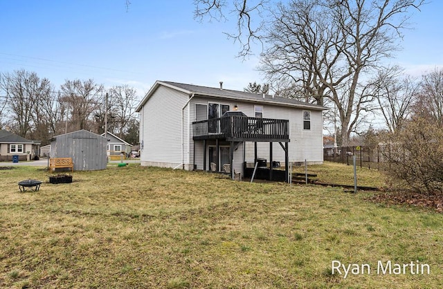 back of house featuring a storage unit, a yard, and a deck