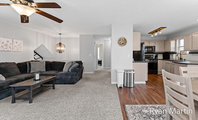 living room featuring baseboards and ceiling fan