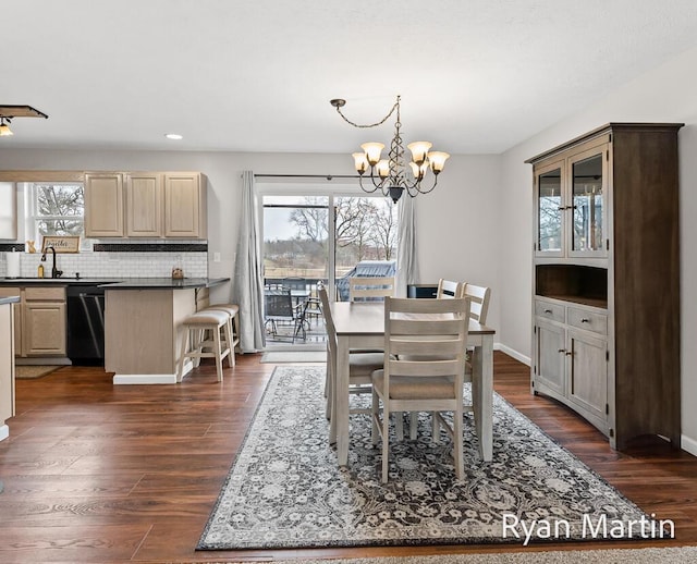 dining space with recessed lighting, baseboards, dark wood finished floors, and a notable chandelier