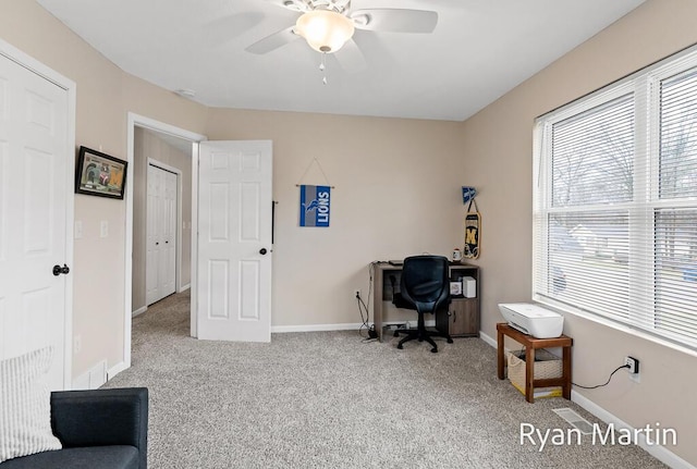 office featuring carpet floors, a ceiling fan, and baseboards