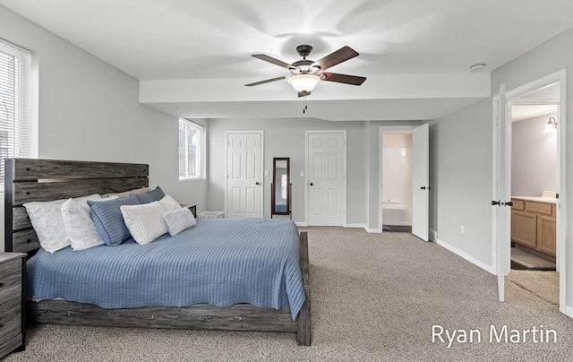 carpeted bedroom with baseboards, a ceiling fan, and ensuite bathroom