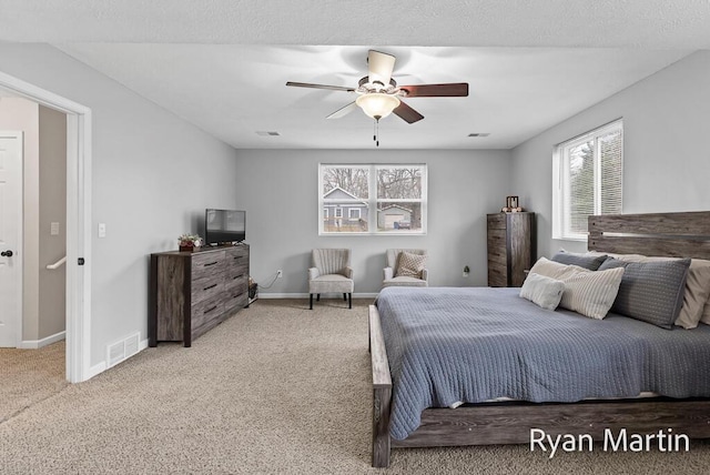 bedroom featuring visible vents, baseboards, and light carpet
