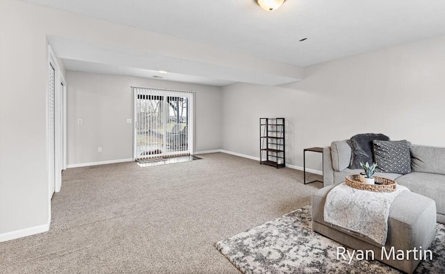 carpeted living room with baseboards