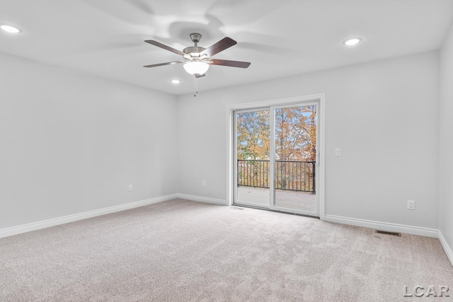 empty room with visible vents, recessed lighting, carpet, and ceiling fan
