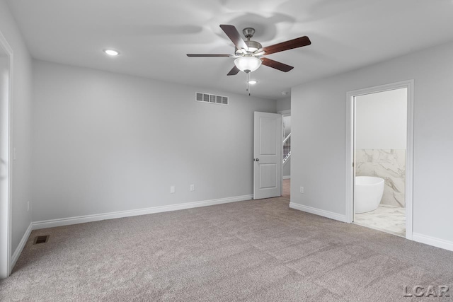 unfurnished bedroom featuring baseboards, carpet, and visible vents