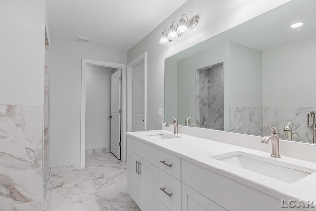 bathroom with double vanity, a sink, marble finish floor, and visible vents