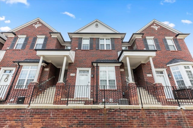 townhome / multi-family property featuring brick siding