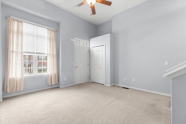 unfurnished bedroom featuring carpet floors, baseboards, and multiple windows