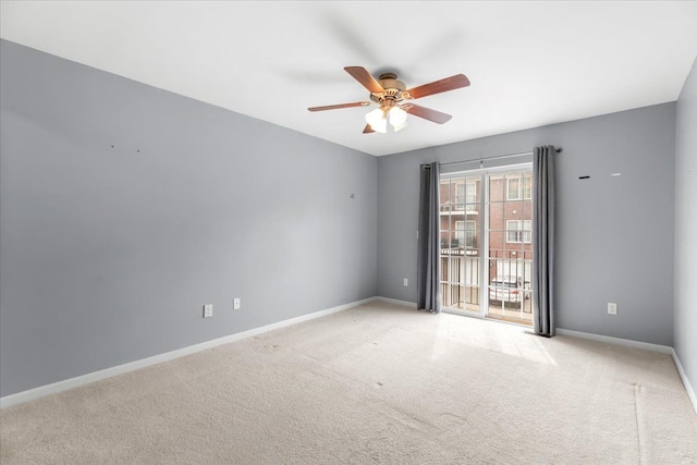 unfurnished room with ceiling fan, light carpet, and baseboards