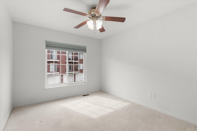 unfurnished room featuring carpet flooring, baseboards, and visible vents