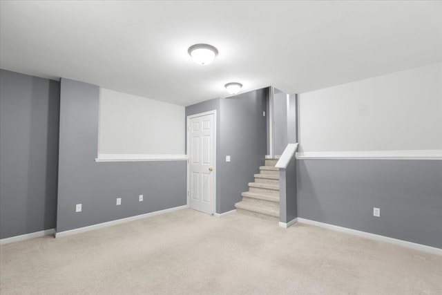 basement with stairway, baseboards, and carpet flooring