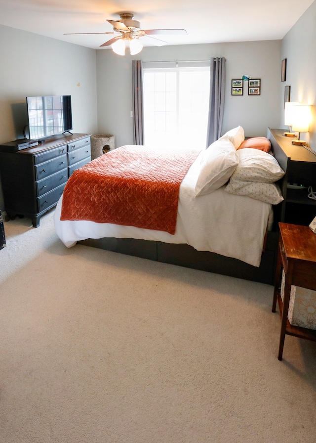 bedroom featuring a ceiling fan and light colored carpet