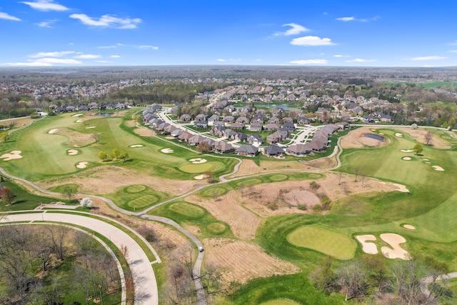 drone / aerial view with view of golf course and a residential view
