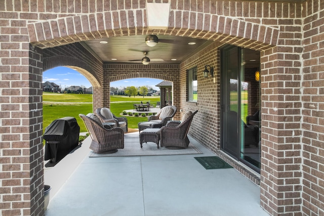 view of patio / terrace with a ceiling fan, grilling area, and golf course view