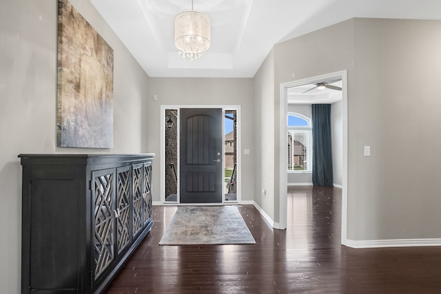entryway featuring baseboards, a tray ceiling, and hardwood / wood-style flooring