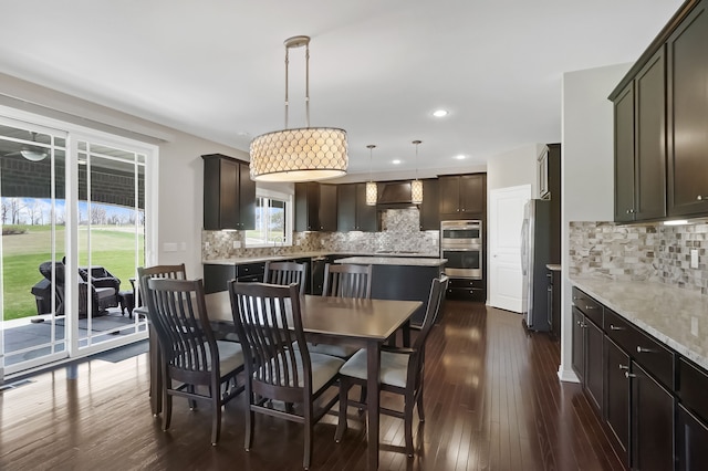dining area featuring recessed lighting and dark wood finished floors