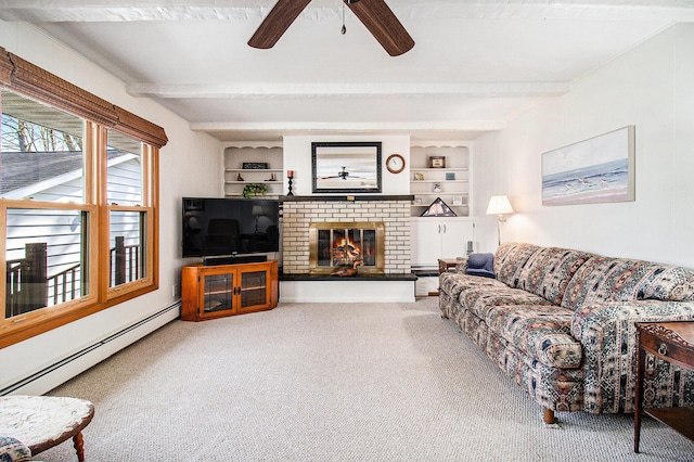 carpeted living area featuring beamed ceiling, ceiling fan, a brick fireplace, and a baseboard radiator