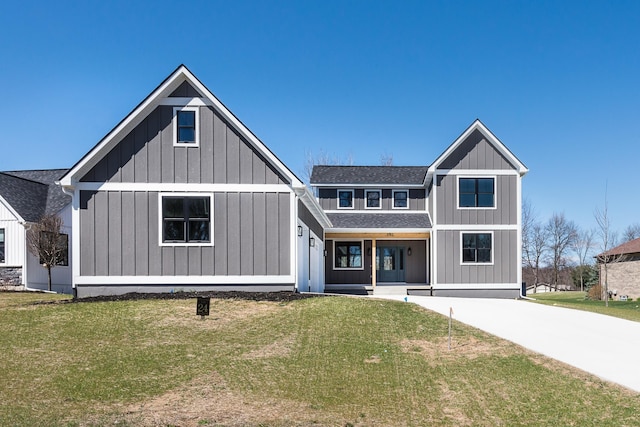 modern farmhouse style home featuring board and batten siding, roof with shingles, and a front lawn