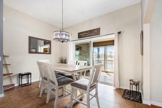 tiled dining room featuring baseboards and a notable chandelier