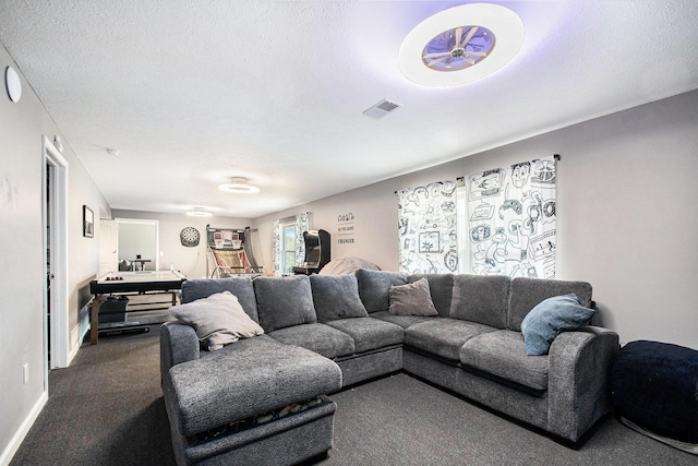 living room featuring dark carpet, a textured ceiling, and visible vents