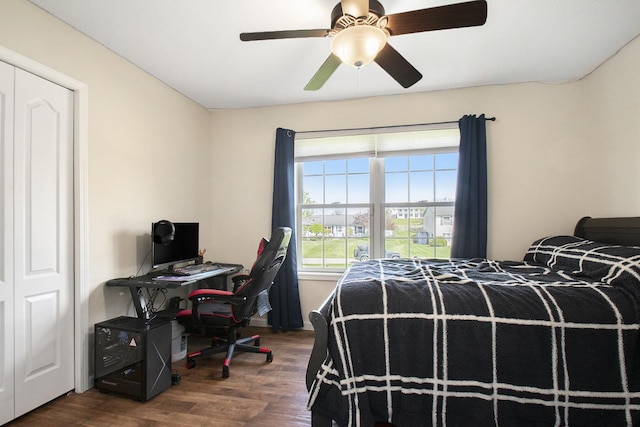 bedroom with ceiling fan and dark wood-style floors