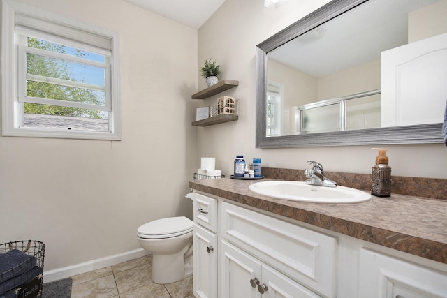 bathroom with vanity, toilet, baseboards, tile patterned floors, and a shower stall