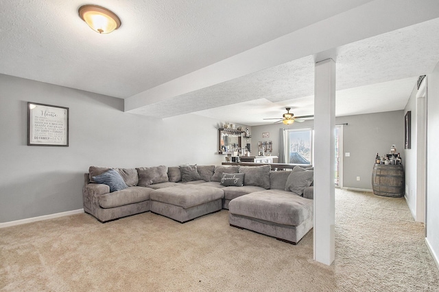 living area with a textured ceiling and light carpet