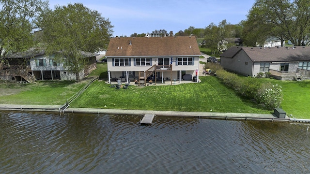 back of property featuring a deck with water view, stairs, a lawn, and a patio