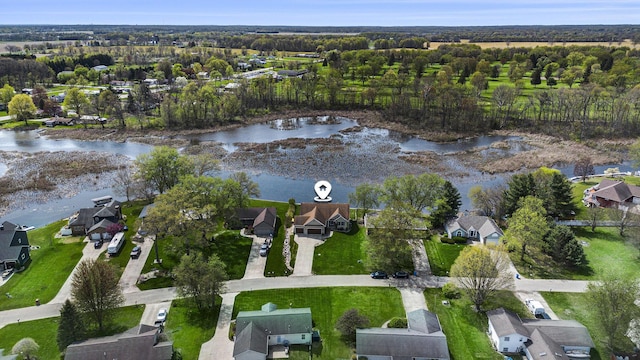 drone / aerial view featuring a water view and a residential view